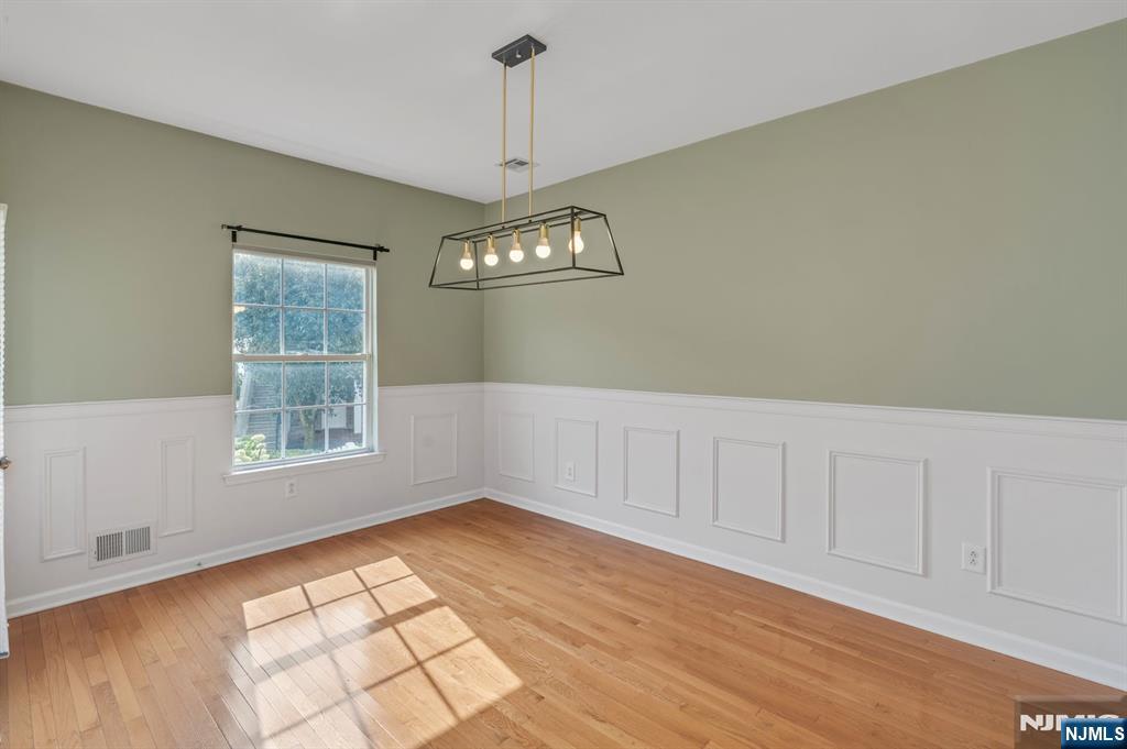 66 Bergen Ridge Road, Unit 1 North Bergen, NJ 07047 - Photo 10 of 26 a view of an empty room with a window and chandelier