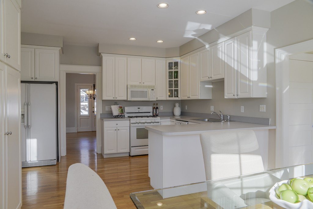 16 Winthrop Road Lexington, MA 02421 - Photo 12 of 29 a kitchen with stainless steel appliances granite countertop a refrigerator sink and white cabinets