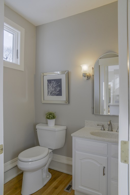 16 Winthrop Road Lexington, MA 02421 - Photo 16 of 29 a bathroom with a toilet sink vanity and mirror