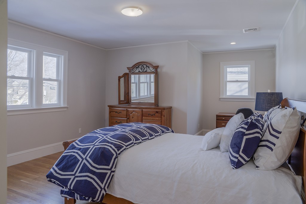 16 Winthrop Road Lexington, MA 02421 - Photo 21 of 29 a bedroom with a bed and wooden floor
