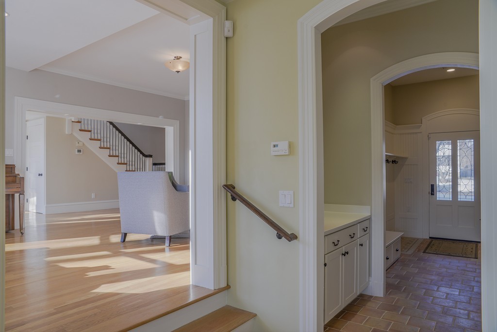 16 Winthrop Road Lexington, MA 02421 - Photo 9 of 29 a view of a hallway with paintings on the wall