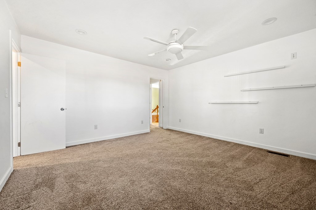 2040 Maples Branch Road Sevierville, TN 37876 - Photo 27 of 40 an empty room with a ceiling fan and a window