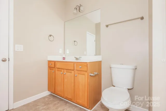 a bathroom with a toilet a sink and a mirror