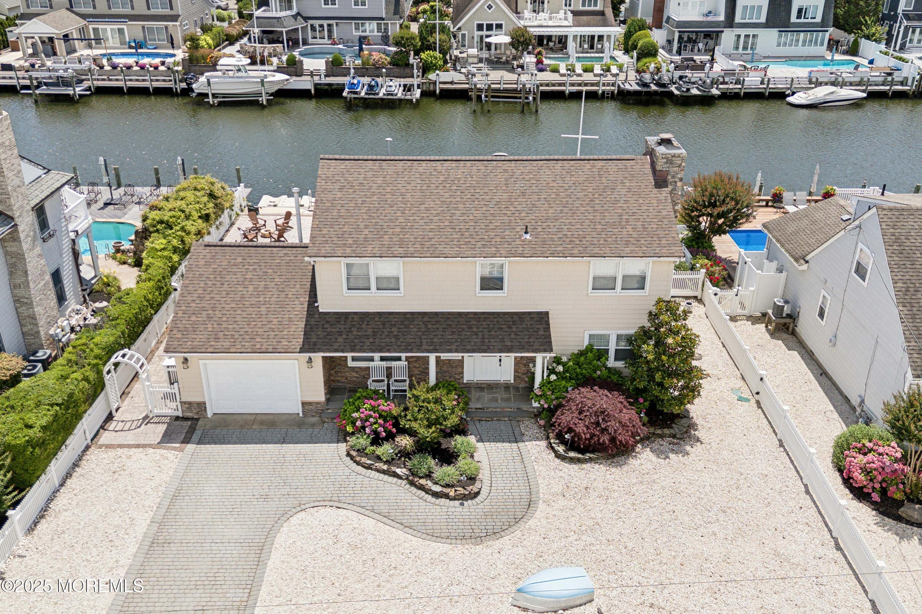 a view of a house with outdoor space and a lake view