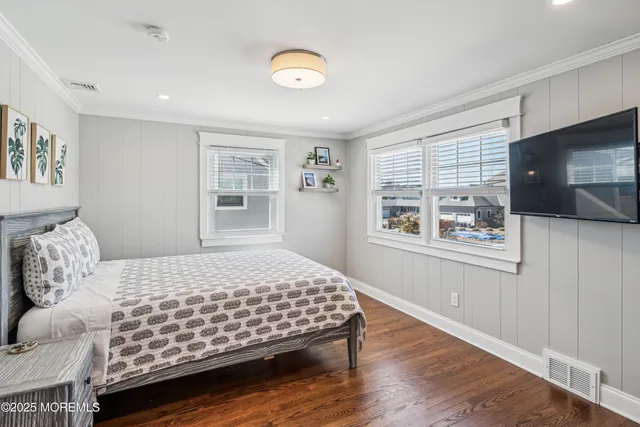 a bedroom with a bed and a television