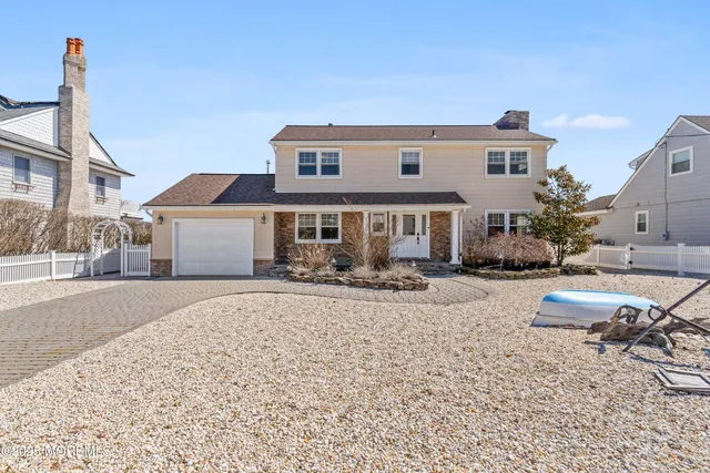 a front view of a house with yard and sitting area