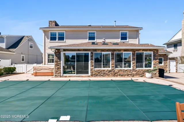 an aerial view of a house with outdoor seating