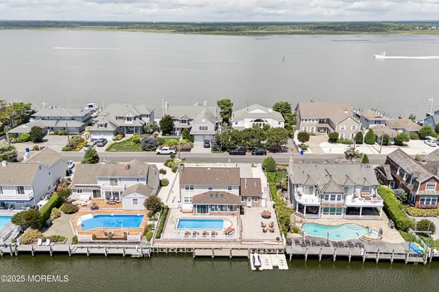 an aerial view of a houses with ocean view