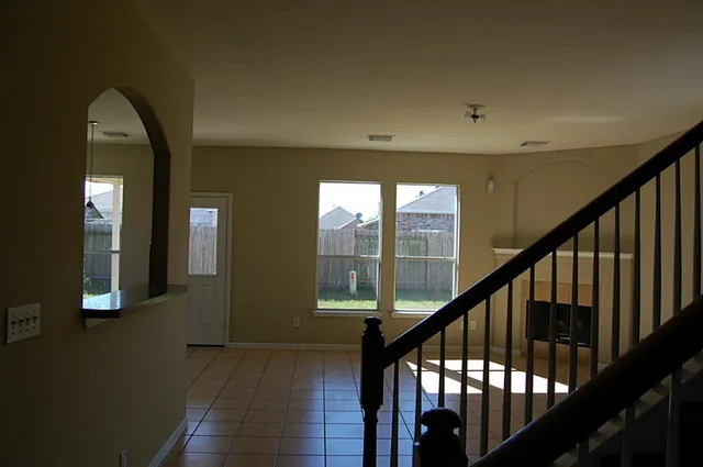 a view of staircase with lots of frames on wall and a potted plant