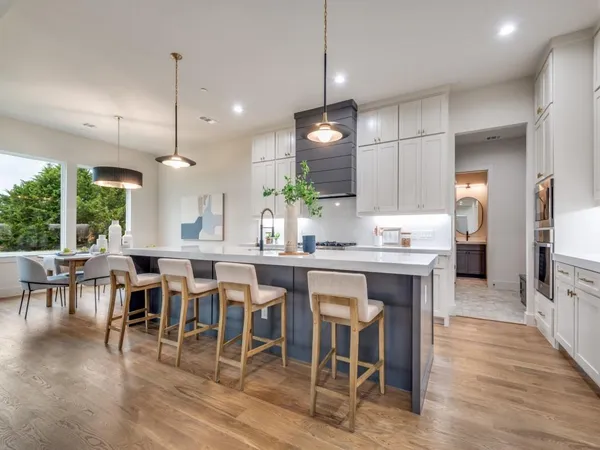 a large kitchen with a table and chairs
