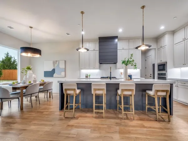 a large kitchen with a table and chairs in it