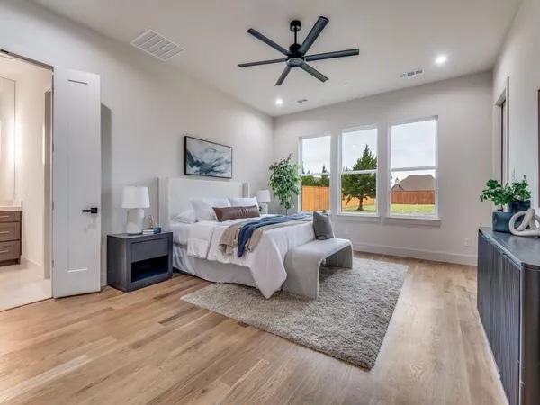 a bedroom with a large bed and a window