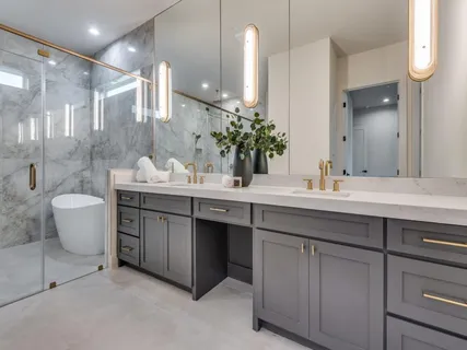 a bathroom with a sink a toilet and shower