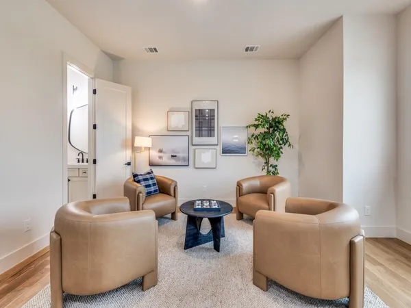 a living room with furniture and a potted plant