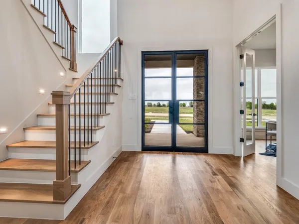 a view of an entryway with wooden floor and windows