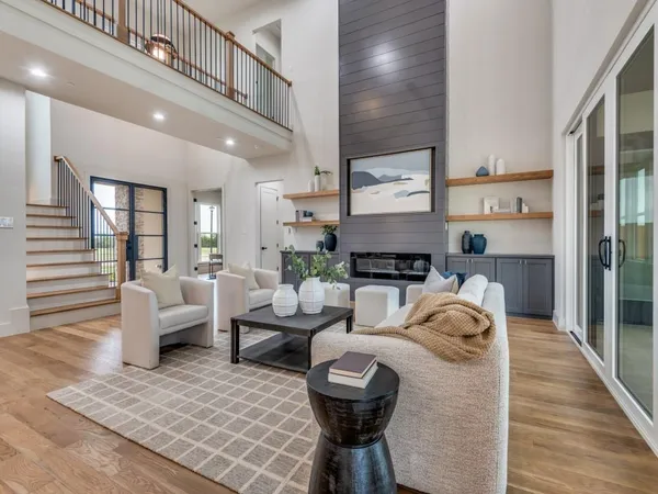 a living room with furniture fireplace and wooden floor