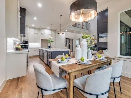 a kitchen with stainless steel appliances granite countertop a sink a stove and a wooden floors