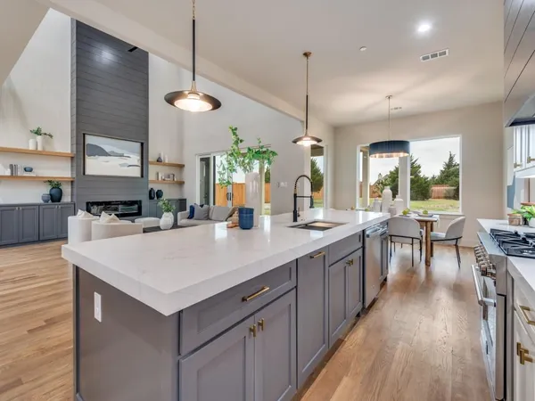 a large kitchen with kitchen island a island a sink a counter space and stainless steel appliances
