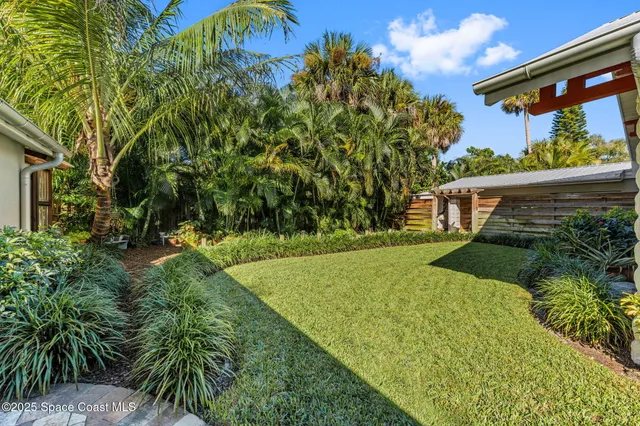 a backyard of a house with plants and garden