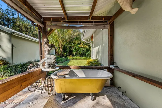 a view of a swimming pool with outdoor seating and plants