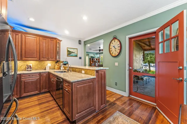 a kitchen with stainless steel appliances granite countertop a refrigerator and a sink