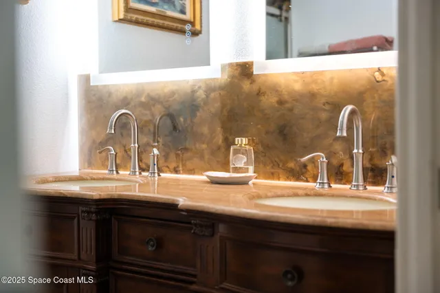 a bathroom with a sink mirror and toilet