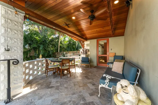 a view of a patio with table and chairs and potted plants