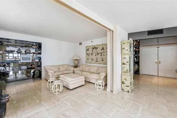 a living room with furniture and a book shelf