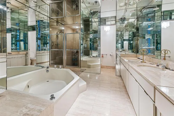 a large white kitchen with a large window and a sink
