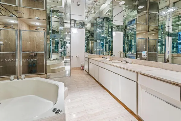 a bathroom with a granite countertop sink mirror and shower