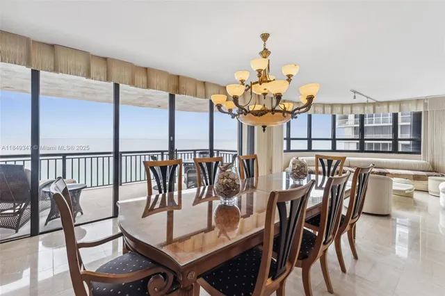 a view of a dining room with furniture a chandelier and wooden floor