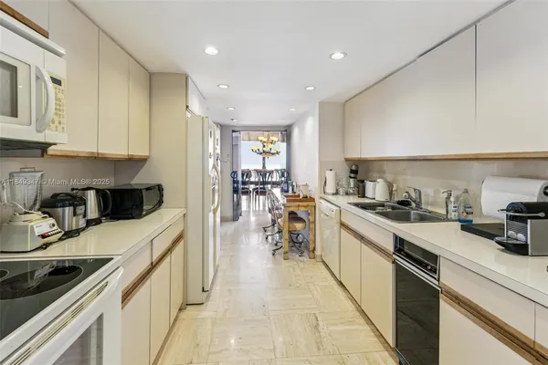 a kitchen with stainless steel appliances granite countertop sink stove top oven and cabinets