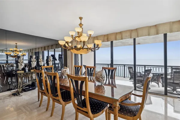 a view of a dining room with furniture and chandelier