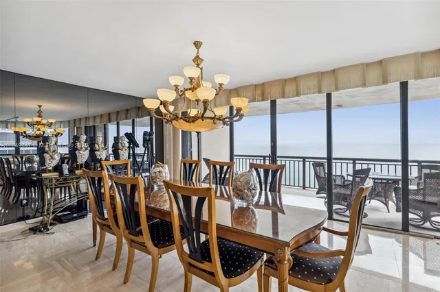 a view of a dining room with furniture and chandelier