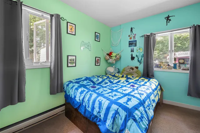 a bedroom with a bed and large window