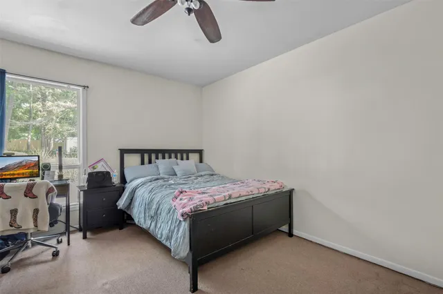 a bed sitting in a room next to a window