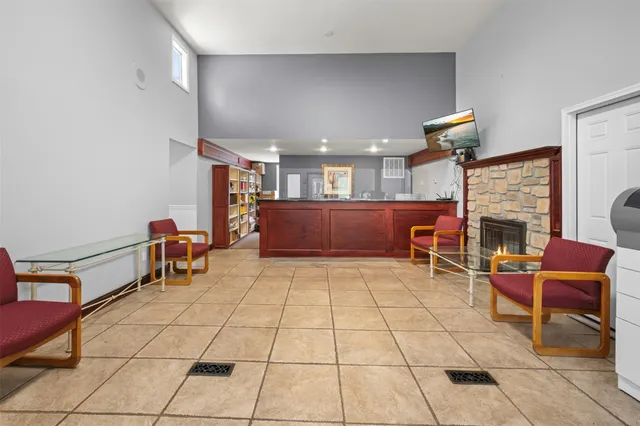 a living room with furniture a fireplace and a table