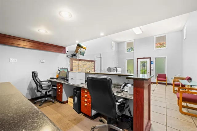 a view of a workspace with furniture and a workspace