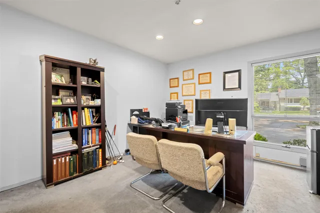 a living room with fireplace furniture and a book shelf
