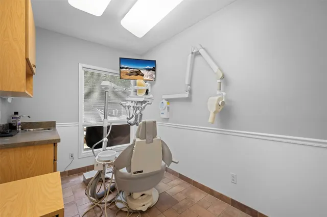 a view of a workspace with furniture and wooden floor