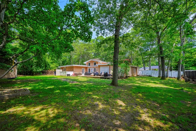 a view of a house with a yard and sitting area