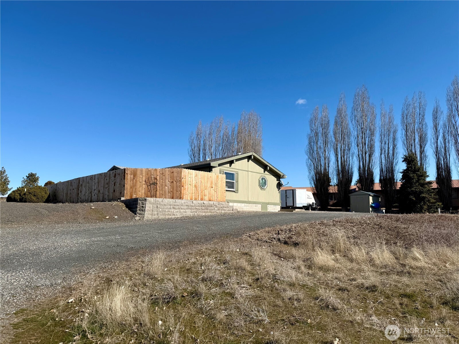 505 Northwest Portland Street Wilbur, WA 99185 - Photo 2 of 40 a view of a house with a yard and large tree