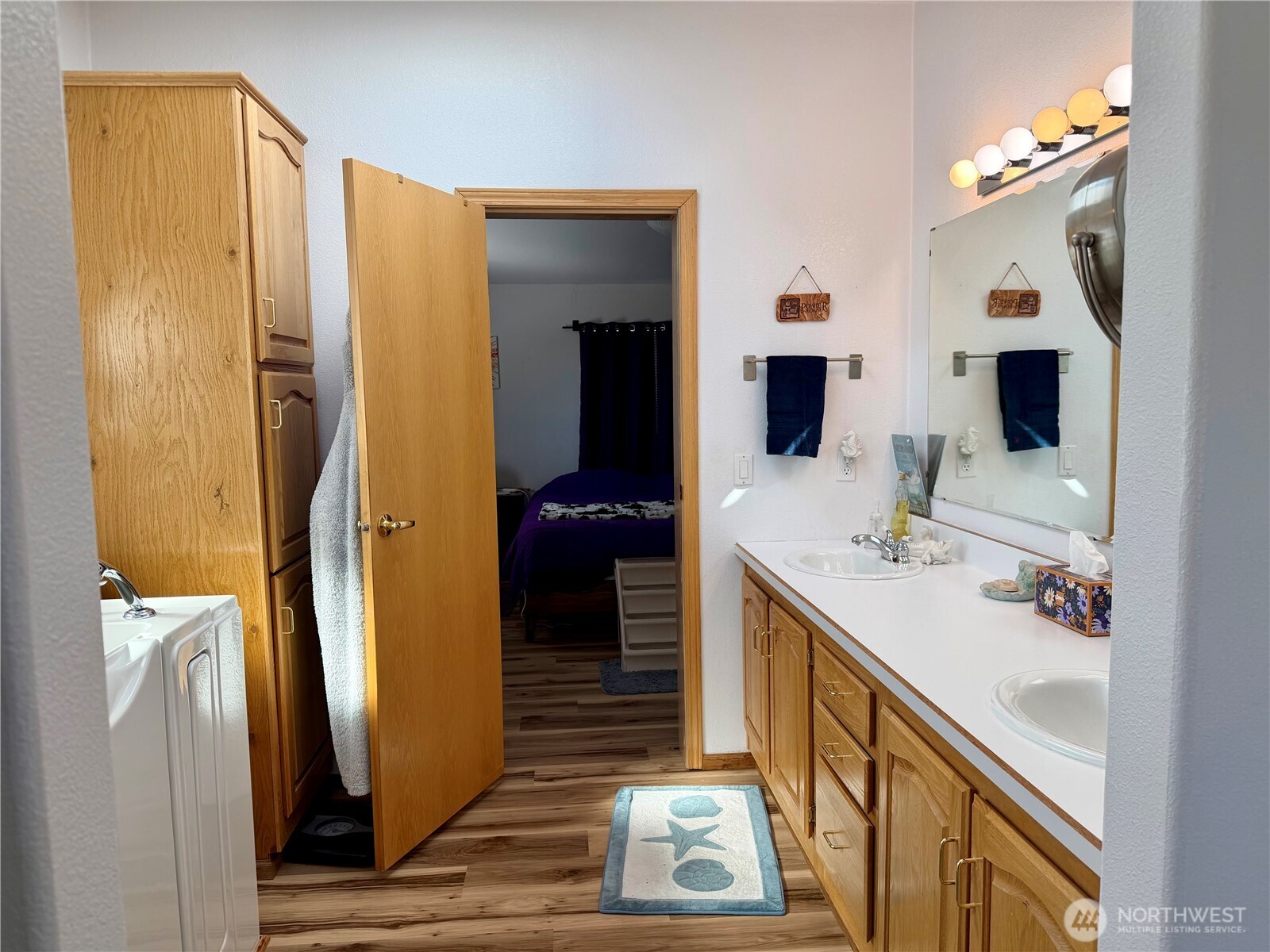 505 Northwest Portland Street Wilbur, WA 99185 - Photo 22 of 40 a bathroom with a double vanity sink and mirror