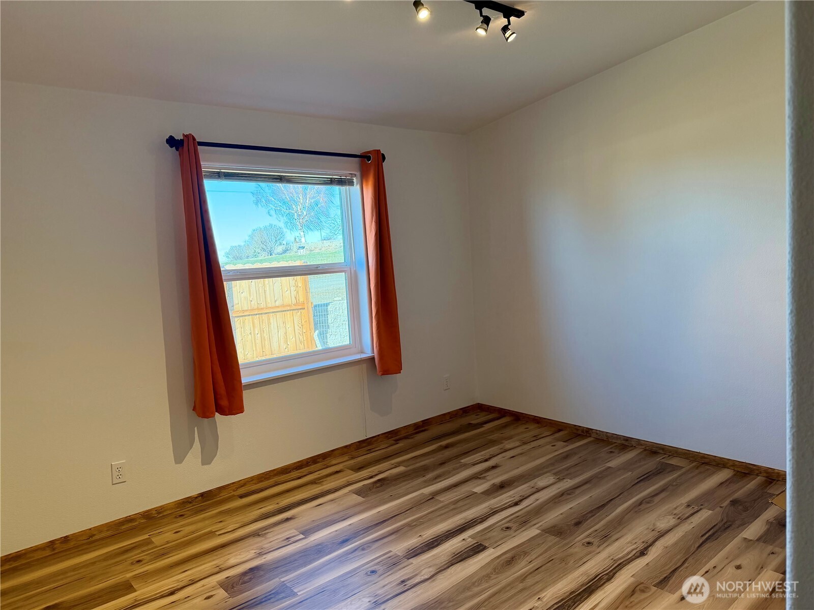 505 Northwest Portland Street Wilbur, WA 99185 - Photo 30 of 40 a view of an empty room with wooden floor and a window