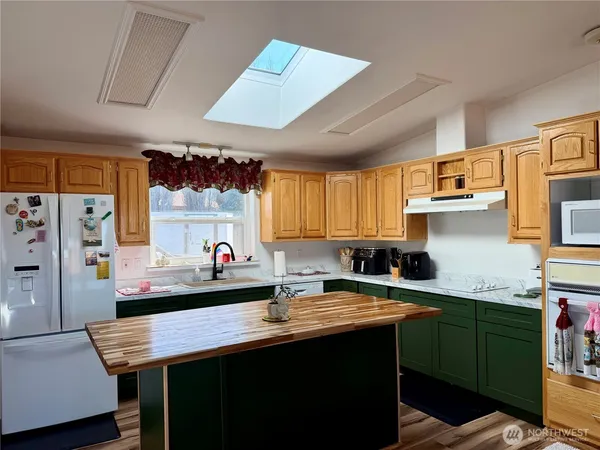 a kitchen with a sink a stove and cabinets