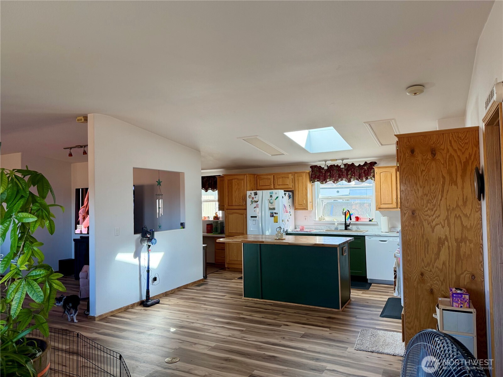 505 Northwest Portland Street Wilbur, WA 99185 - Photo 9 of 40 a view of a kitchen with kitchen island wooden floor and center island