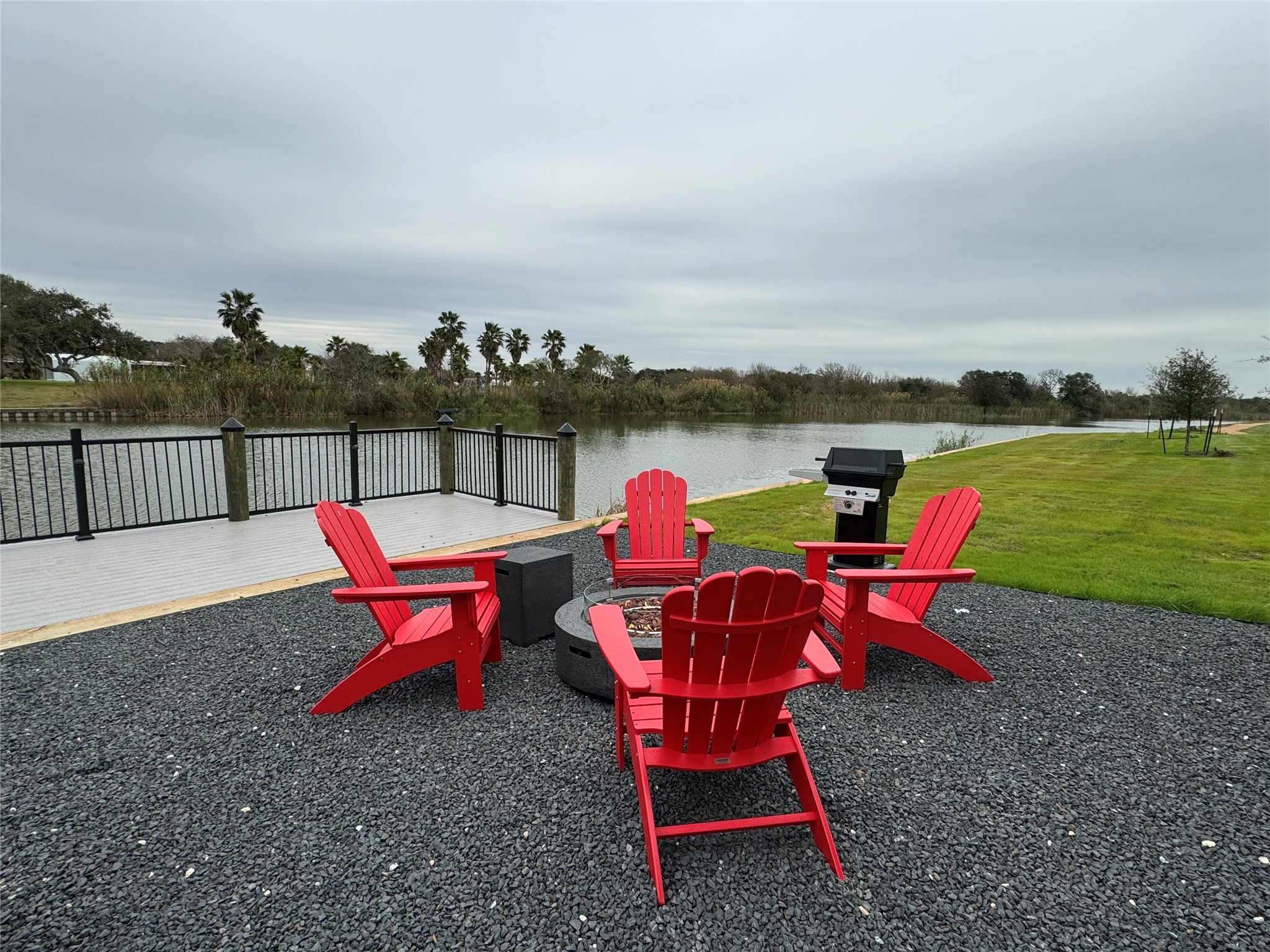 3127 Maverick Loop, Unit 36 Freeport, TX 77541 - Photo 13 of 16 an outdoor sitting area with furniture and lake view