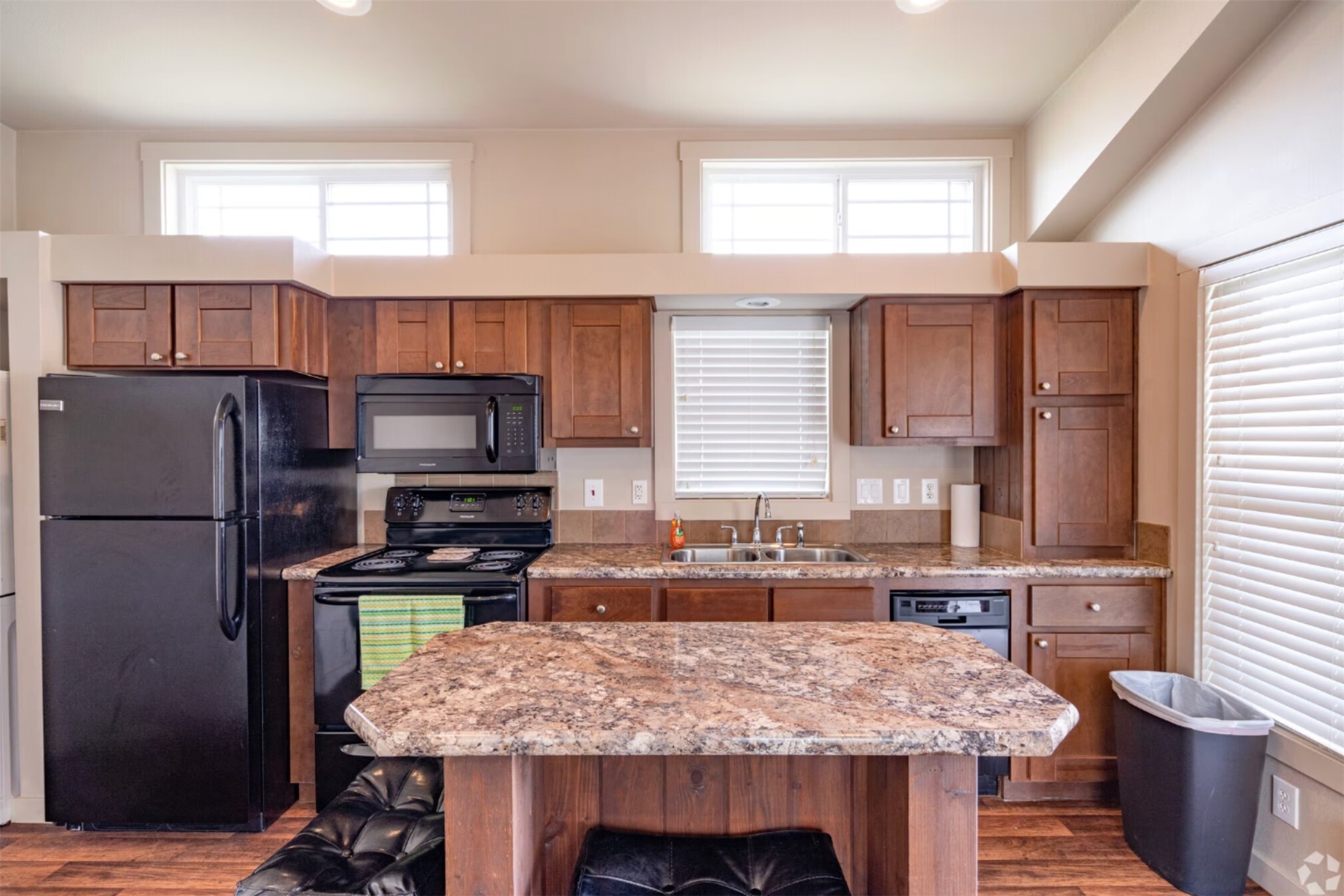 3127 Maverick Loop, Unit 36 Freeport, TX 77541 - Photo 2 of 16 a kitchen with a refrigerator a sink and wooden cabinets
