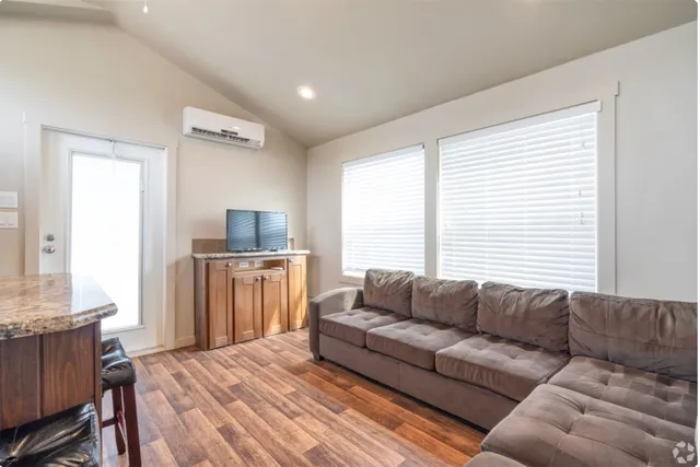 a living room with furniture and a flat screen tv