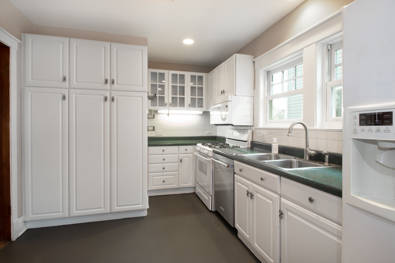 261 Blackhawk Road Riverside, IL 60546 - Photo 11 of 31 a kitchen with granite countertop white cabinets and stainless steel appliances
